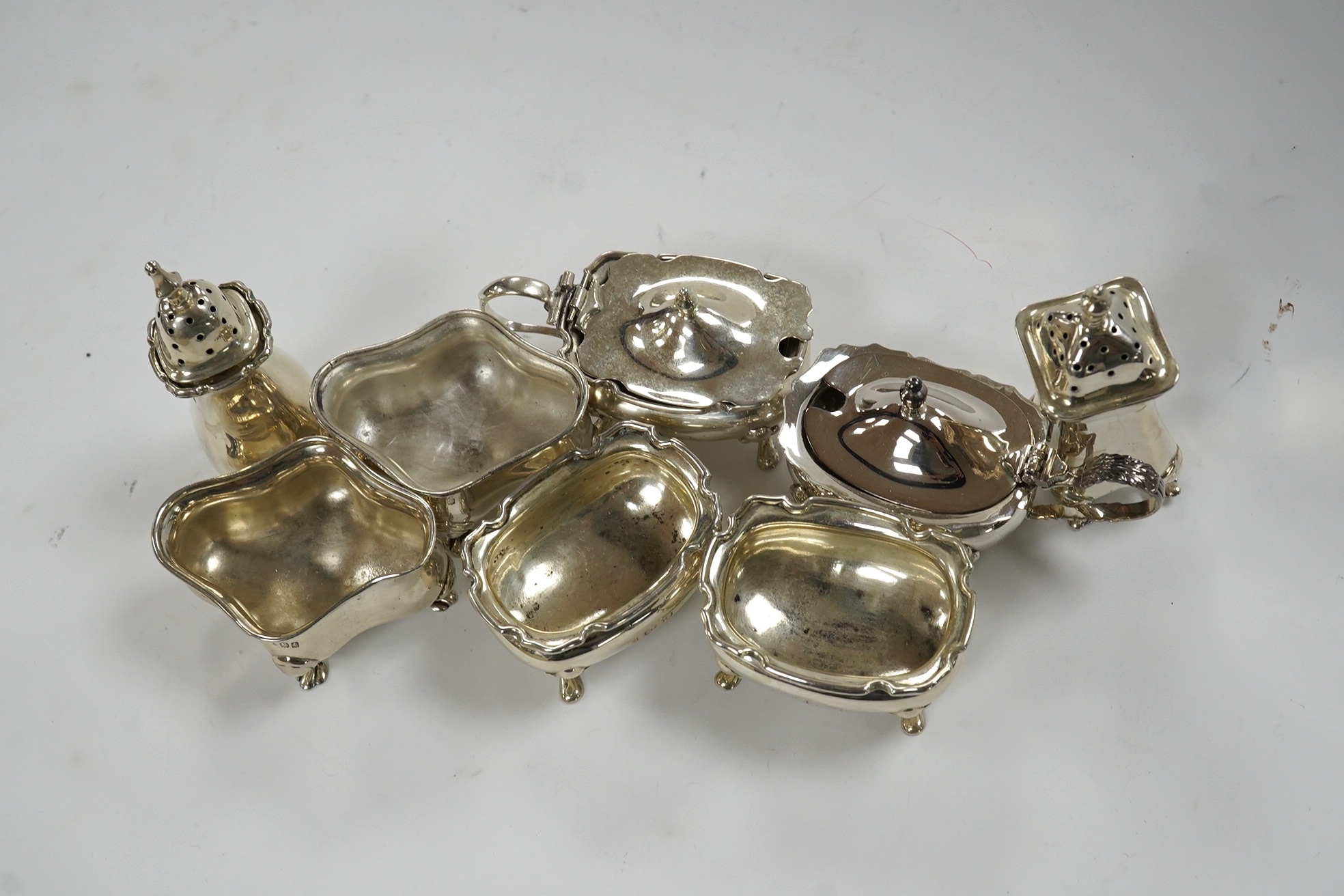 Eight assorted silver cruets including salts and mustard pots, various dates and makers, Condition - poor to fair